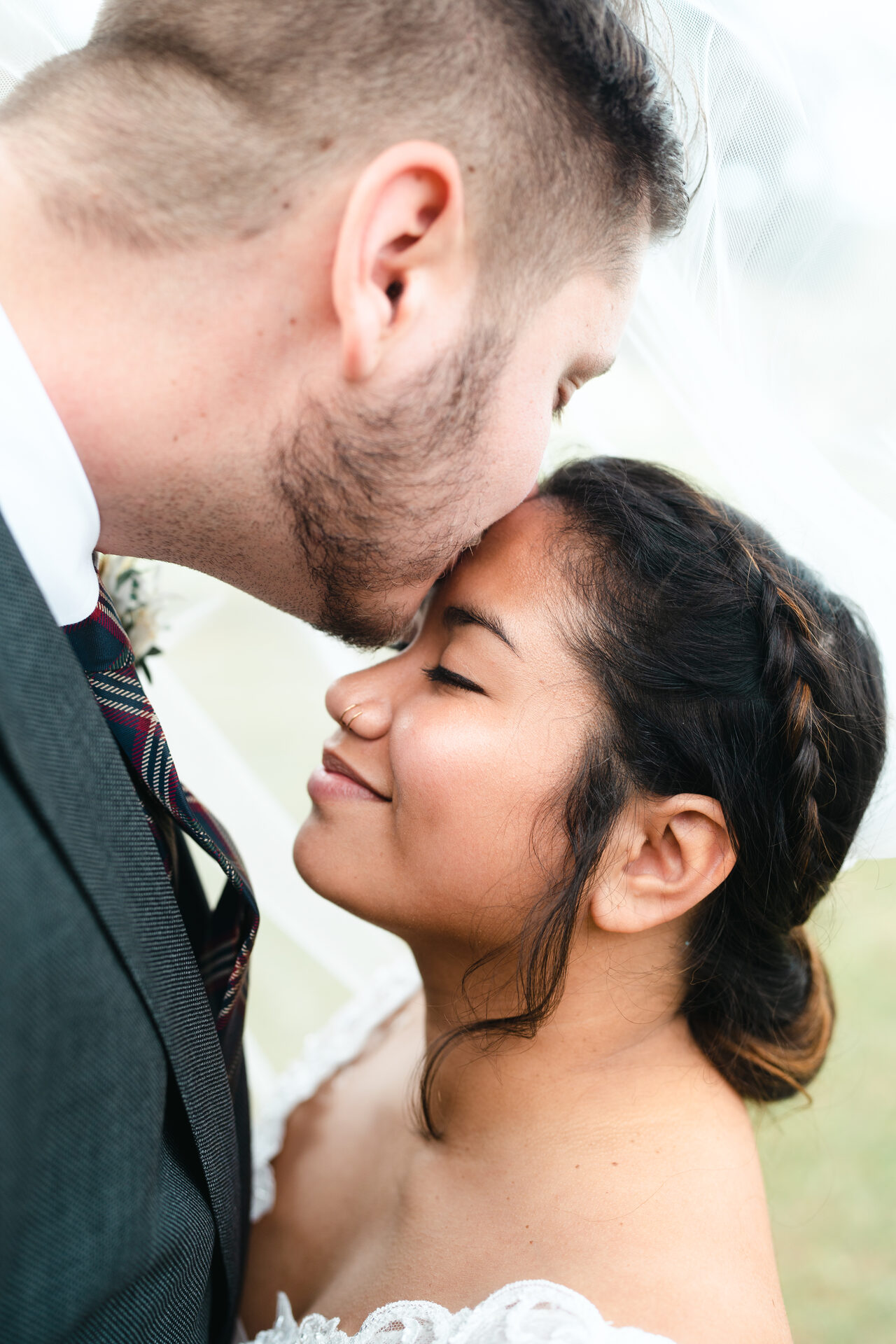Wedding photographer Orlando FL — intimate forehead kiss, bridal veil